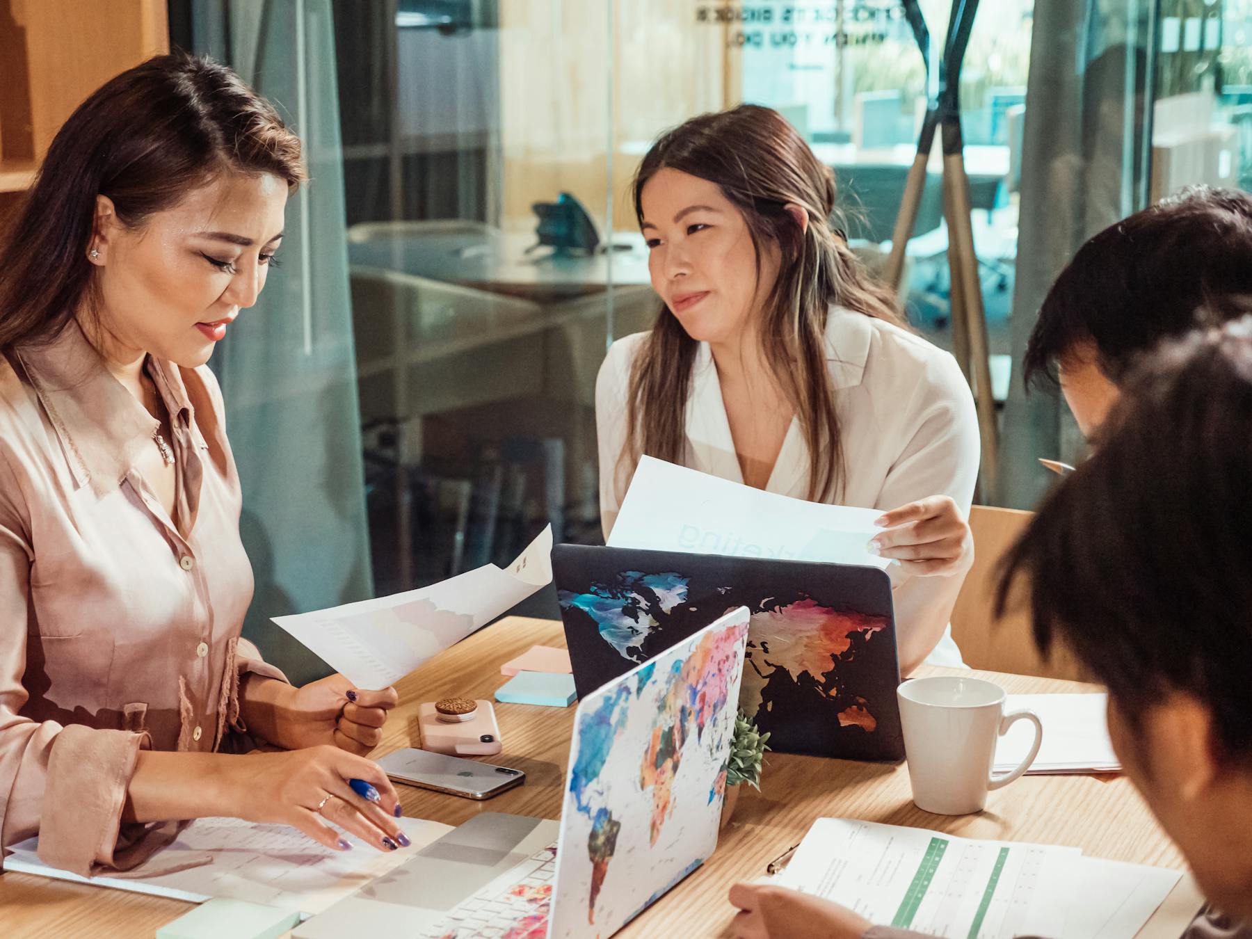 Asian professionals collaborating in a modern office strategy meeting