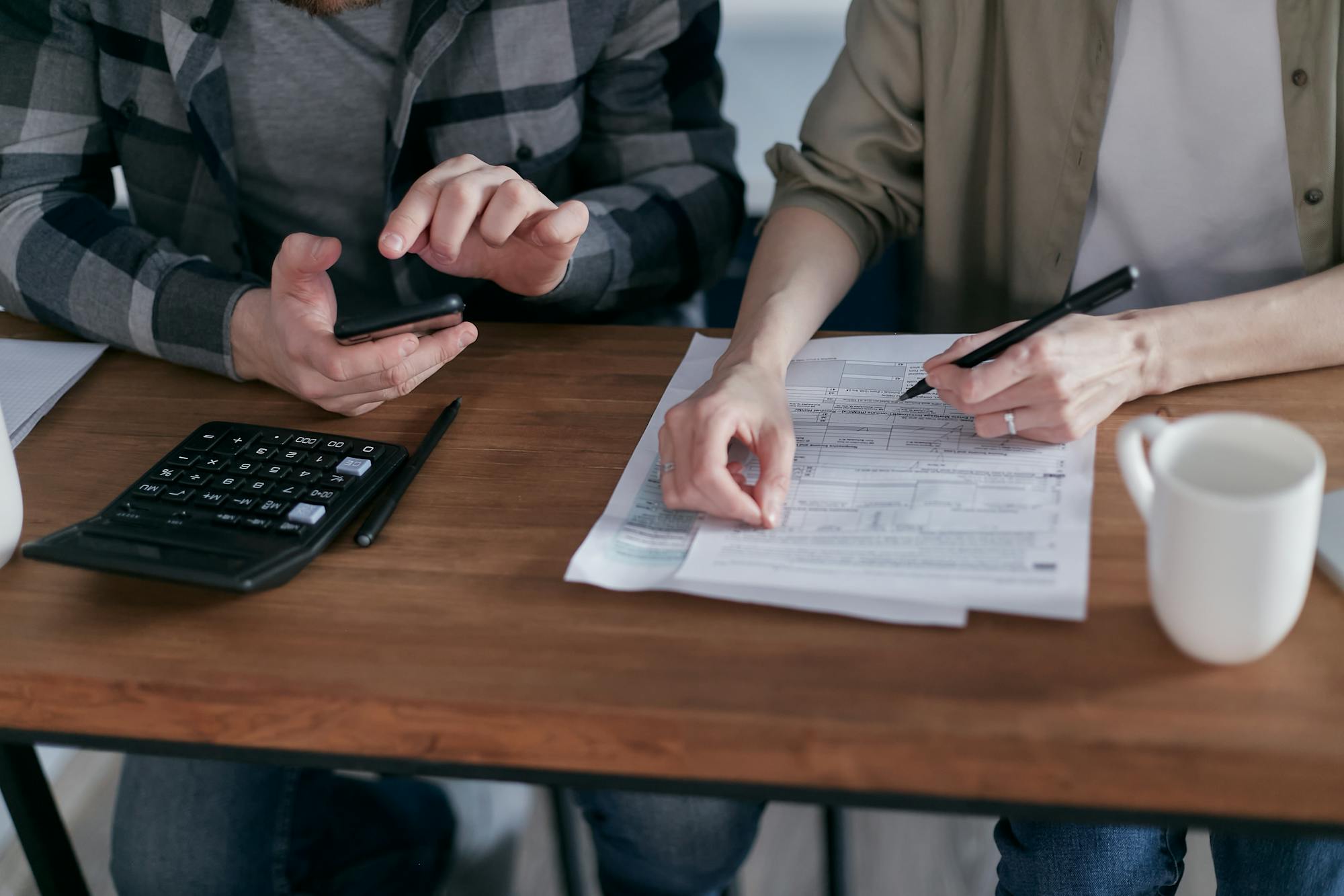 Team reviewing tax paperwork and calculations at a desk